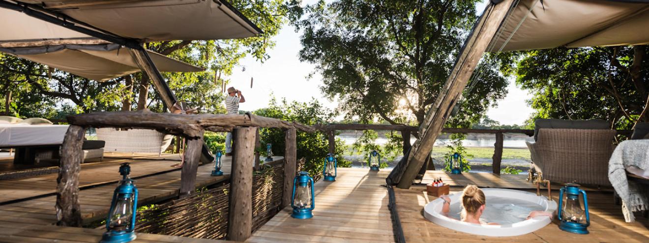 Shawa Luangwa Camp luxury tented safari suite nestled in trees along the Luangwa River banks