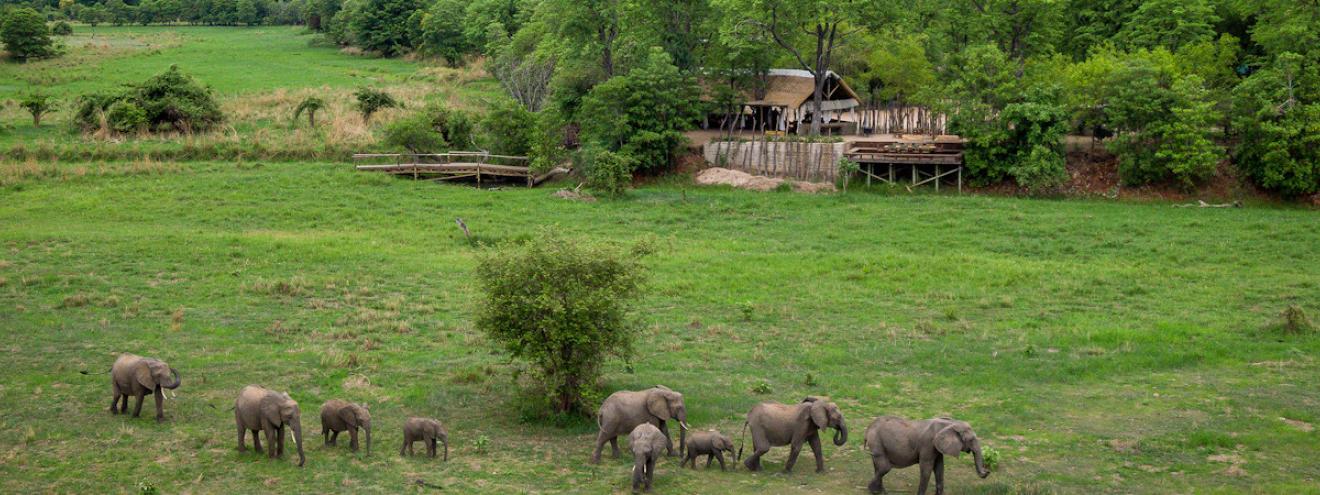 Zungulila Bushcamp classic thatched main boma and lounge area overlooking the scenic Kapamba River edge