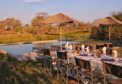 Outdoor dining and swimming pool at camp