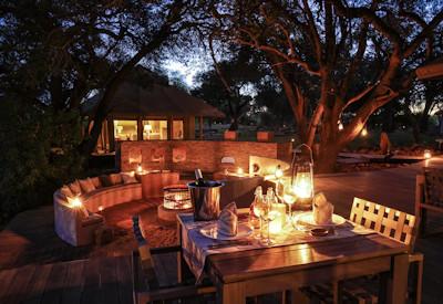 Outdoor dining at night at River Camp