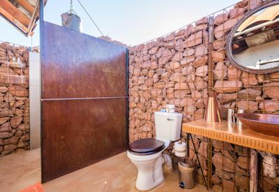 En-suite bathrooms with open air hot bucket showers and flush toilets