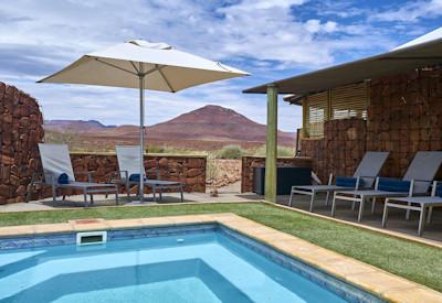 Swimming pool with towering basalt mountains