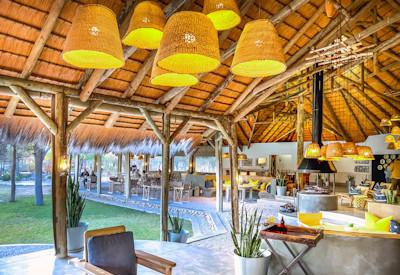 Thatched dining area overlooking the surrounding bush