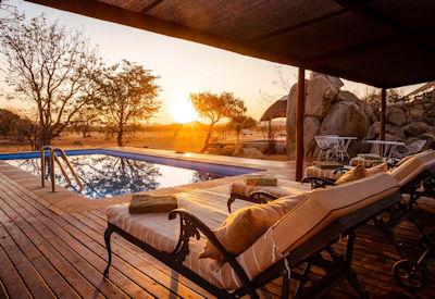 Swimming pool with wooden deck and sun loungers