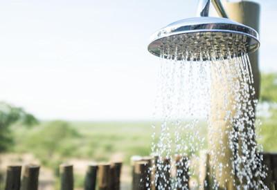 Outdoor rain showers overlooking a watering hole