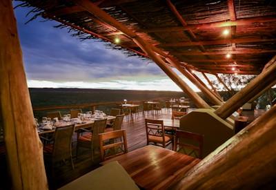 Outdoor dining area at lodge with views of a private game reserve