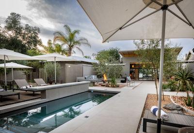 Outdoor pool with sun loungers and umbrellas
