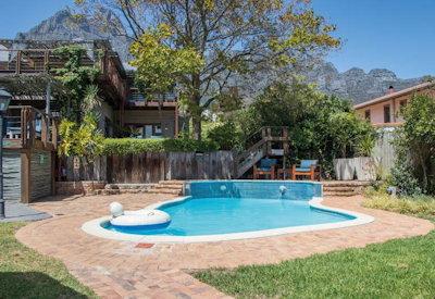 Outdoor pool and lush green nature reserve