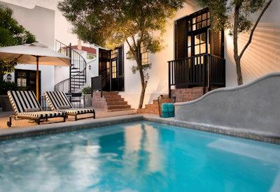 Sparkling swimming pool and lush gardens