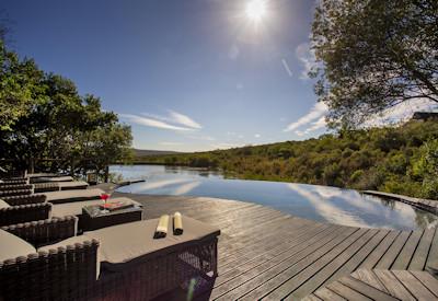 Rim flow swimming pool with viewing deck