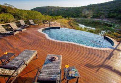 Rim flow pool with sun loungers