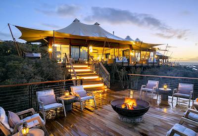 Wooden deck area with fire and seating