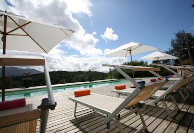 A swimming pool with sun loungers
