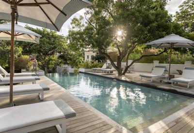 Swimming pool with sun loungers