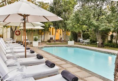 Swimming pool with sun loungers