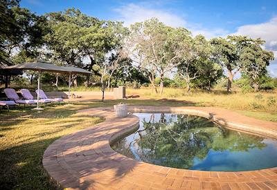 Large pool with sun loungers and umbrellas