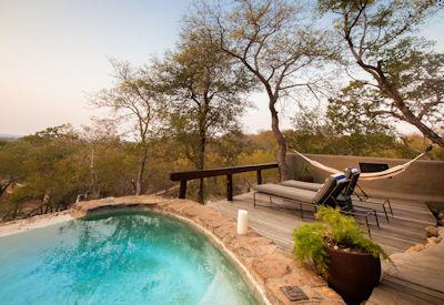 Private swimming pool with sun deck and loungers