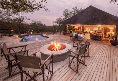 Indoor and outdoor dining areas with fire pit