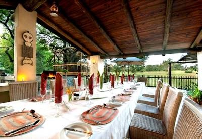Thatched dining area with paraffin lamps