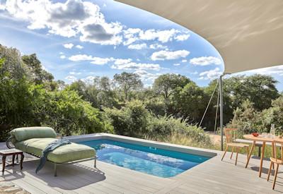 Glass doors open onto a private plunge pools