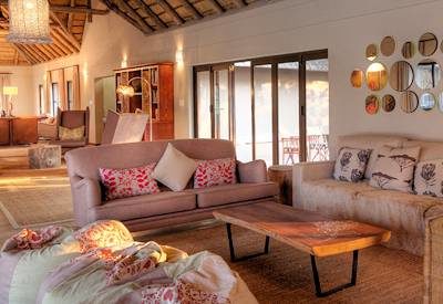 Thatched lounge and library area at private camp