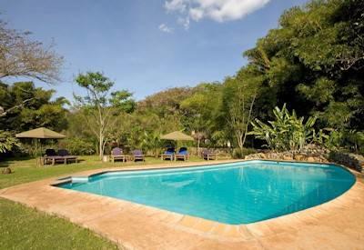 Plantation lodge's pool nestling under the African sun