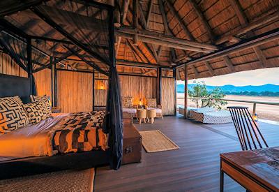 A tree house in a stunning location with black mosquito nets