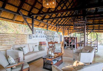 Thatched lounge and small library at safari camp