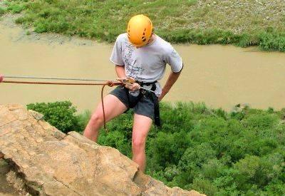 Abseiling team building Africa cliff descent harness ropes professional instructors corporate adventure