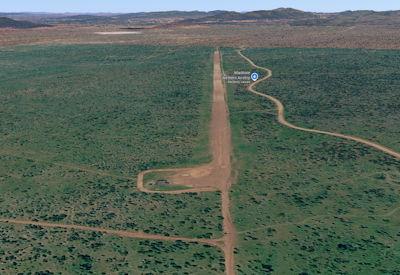 Gravel bush airstrip cut through the trees inside the Madikwe Game Reserve, North West Province