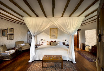 andBeyond Klein's Camp classic luxury chalet dark wood rich interiors Kuka Hills Tanzania
