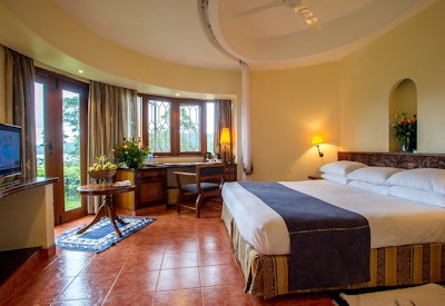 Arusha Serena Hotel luxurious en-suite bedroom stone cottage minibar satellite TV Tanzania