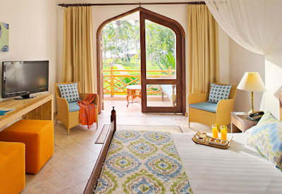 Bluebay Beach Resort classically appointed bedroom Zanzibar furniture satellite TV Tanzania
