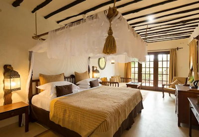 Breezes Beach Club large luxury suite ivory tones teak wood Zanzibar carvings Tanzania