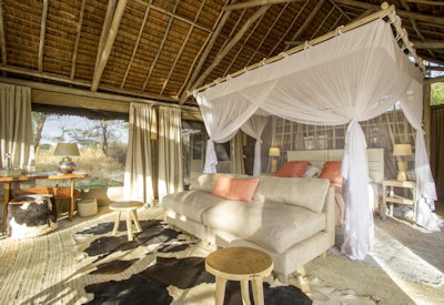 Kuro Tarangire thatched tented suite king bed Tarangire River views Tanzania