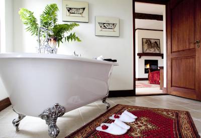 The Manor at Ngorongoro Victorian clawfoot freestanding bath twin basins rainfall shower Tanzania