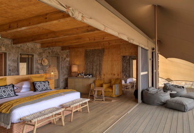 Namiri Plains Camp large tented suite king bed private deck freestanding bath Tanzania