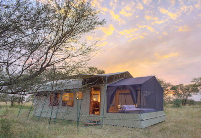 Olakira Migration Camp intimate safari suite king bed chaise lounge veranda Tanzania