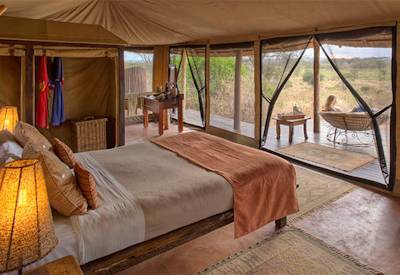 Oliver's Camp leather armchair mahogany headboard open-sided suite Tarangire Tanzania