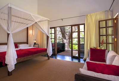 Plantation Lodge large individually decorated bedroom wood-burning stove veranda Tanzania