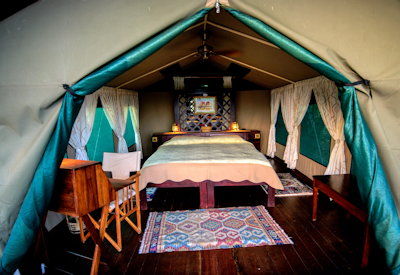 Selous Impala Camp classic safari tent veranda chairs table Rufiji River Tanzania