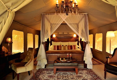 Selous Serena Camp en-suite bedroom crystal chandeliers Rufiji River views Tanzania