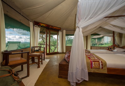 Serengeti Simba Lodge large comfortable bedroom local fabrics hardwood mosquito nets Tanzania