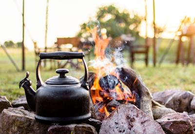 Singita Explorer Tented Camp Grumeti Reserve firepit dinner under stars Tanzania