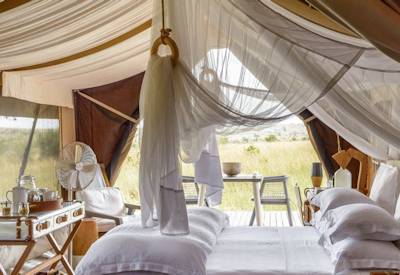 Singita Mara River Tented Camp luxury tented bedroom open-air bathtub river views Tanzania