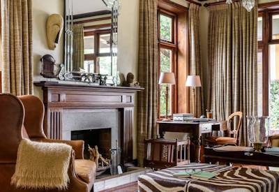 Singita Sasakwa Lodge Edwardian manor house stone walls verandas high ceilings Tanzania