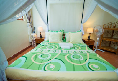 Airport Guesthouse Entebbe large comfortable patio chairs manicured garden Uganda