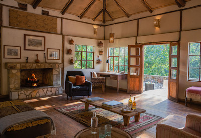 Volcanoes Bwindi Lodge cosy fireplace lounge library Bwindi Forest Uganda