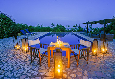 Elephant Plains Lodge swimming pool illuminated night Queen Elizabeth Uganda