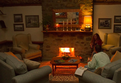 Engagi Lodge lounge comfortable seating fireplace Bwindi Forest views Uganda